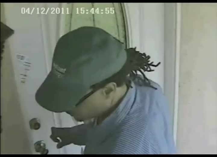 The same camera ninety seconds earlier: a man knocking at the door and waiting