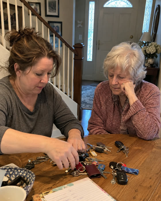 A mother and daughter at the kitchen table sorting through every spare key in the house